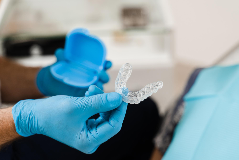 orthodontist shows transparent removable retainer