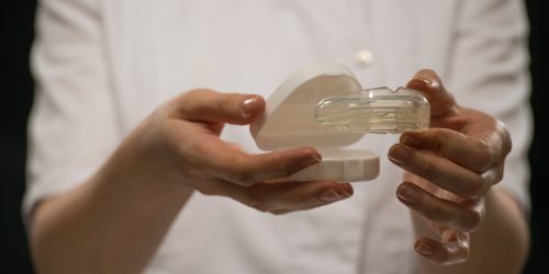 Transparent Mouthguard being held by a lady
