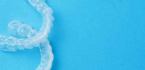 Transparent mouthguards on blue background