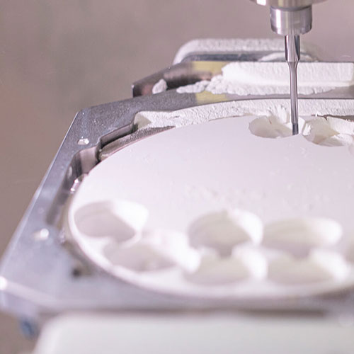Close-up of a dental milling machine in action