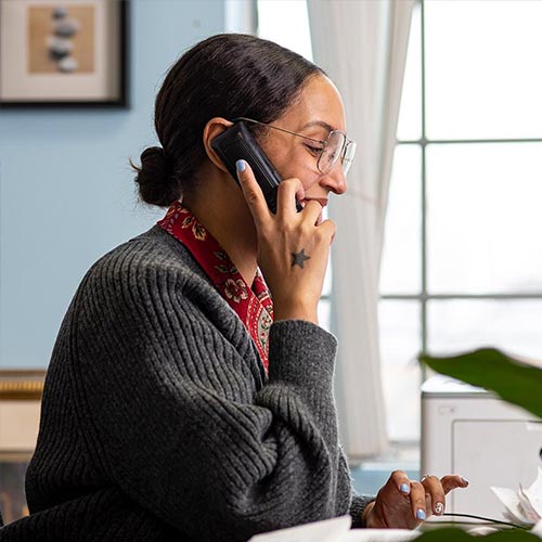 Woman talking on a phone in an office setting