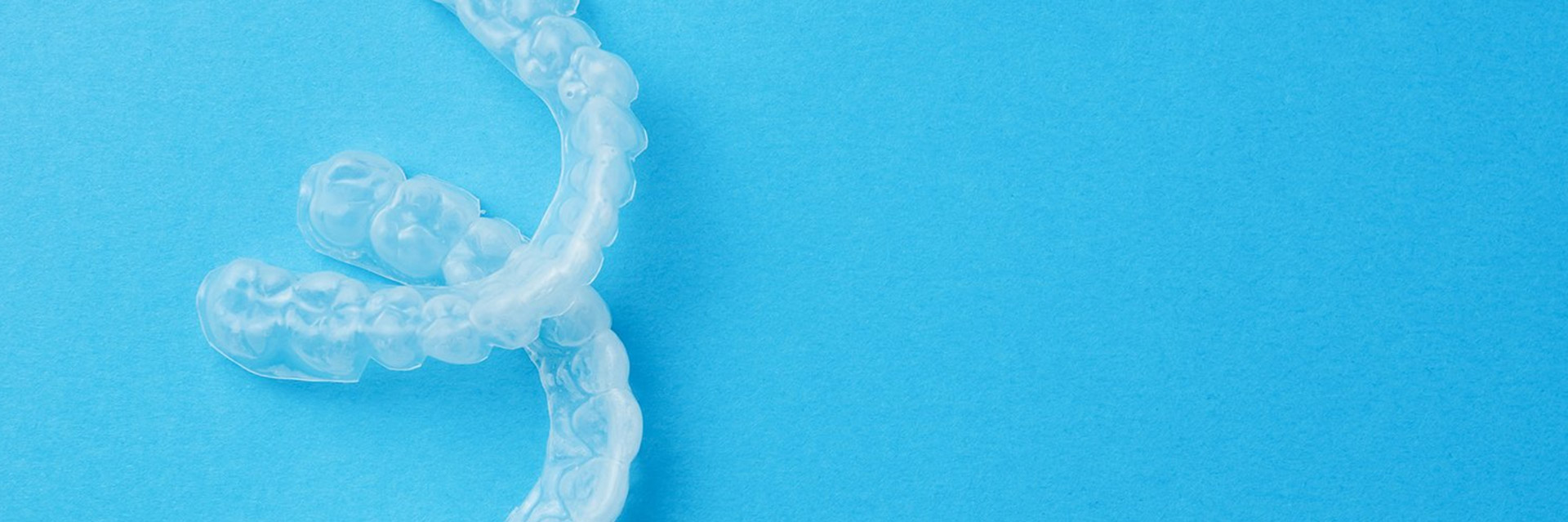 Transparent mouthguards on blue background