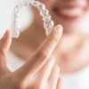 woman holding retainer Clear Orthodontic Retainer