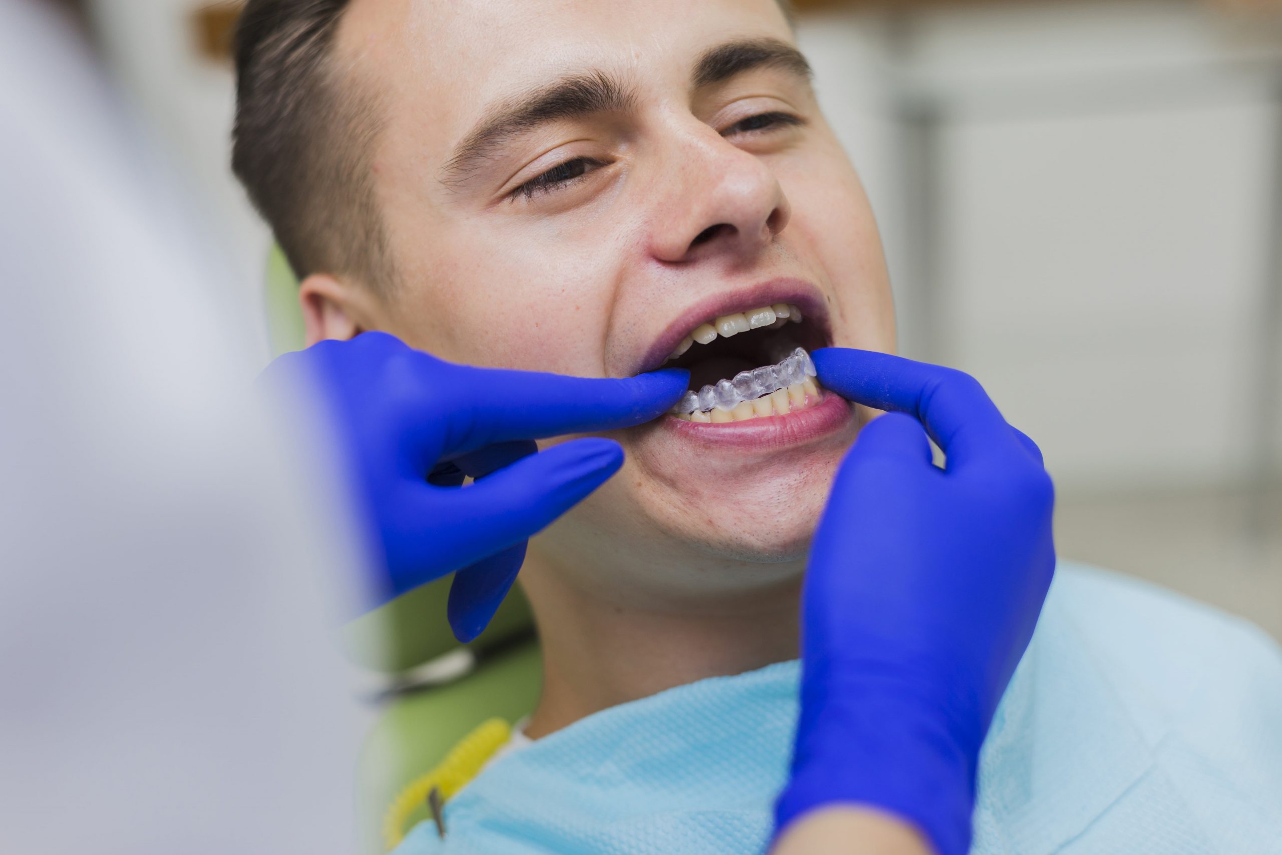 Dentist fixing retainers to patient