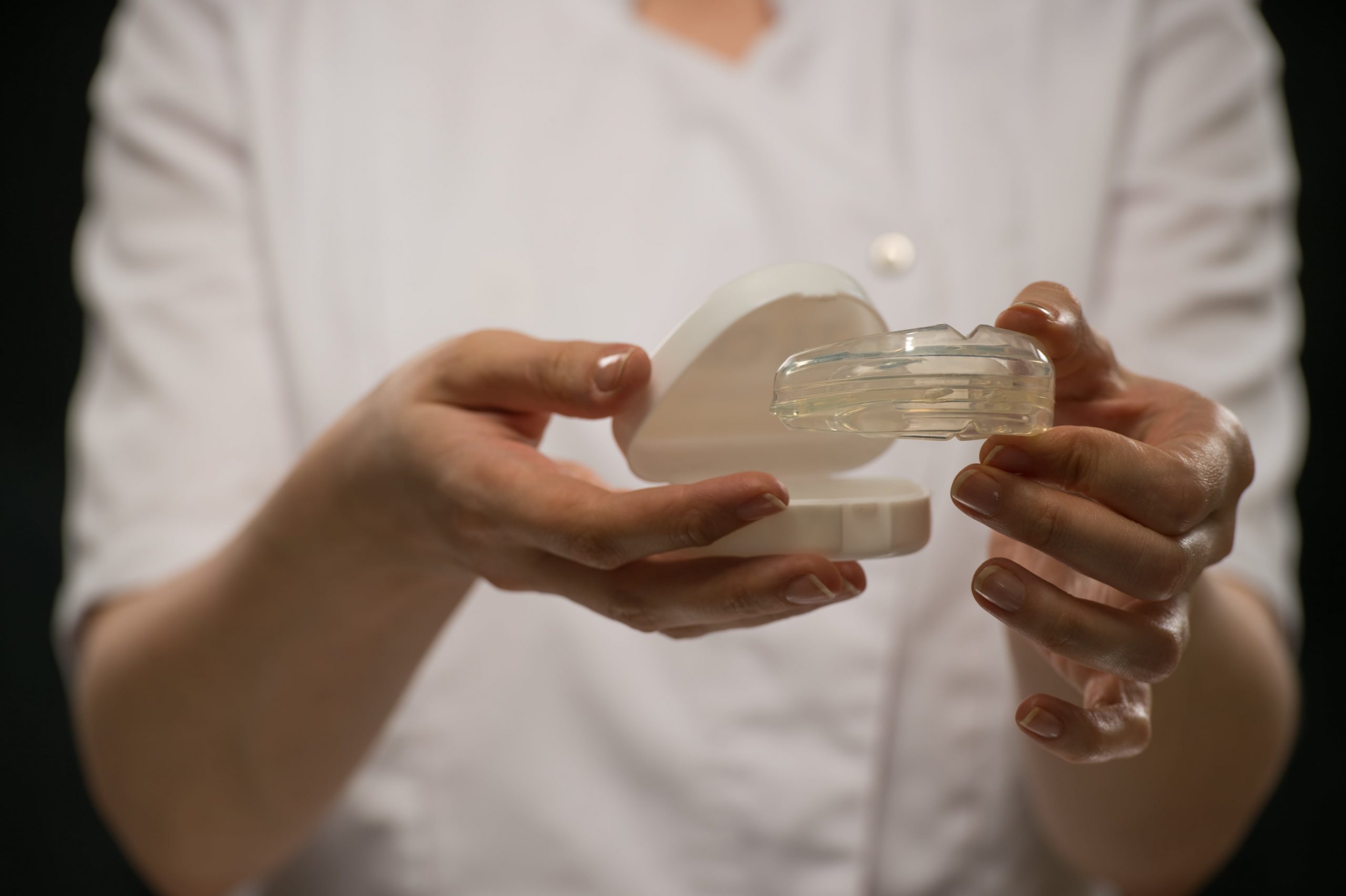 Transparent Mouthguard being held by a lady