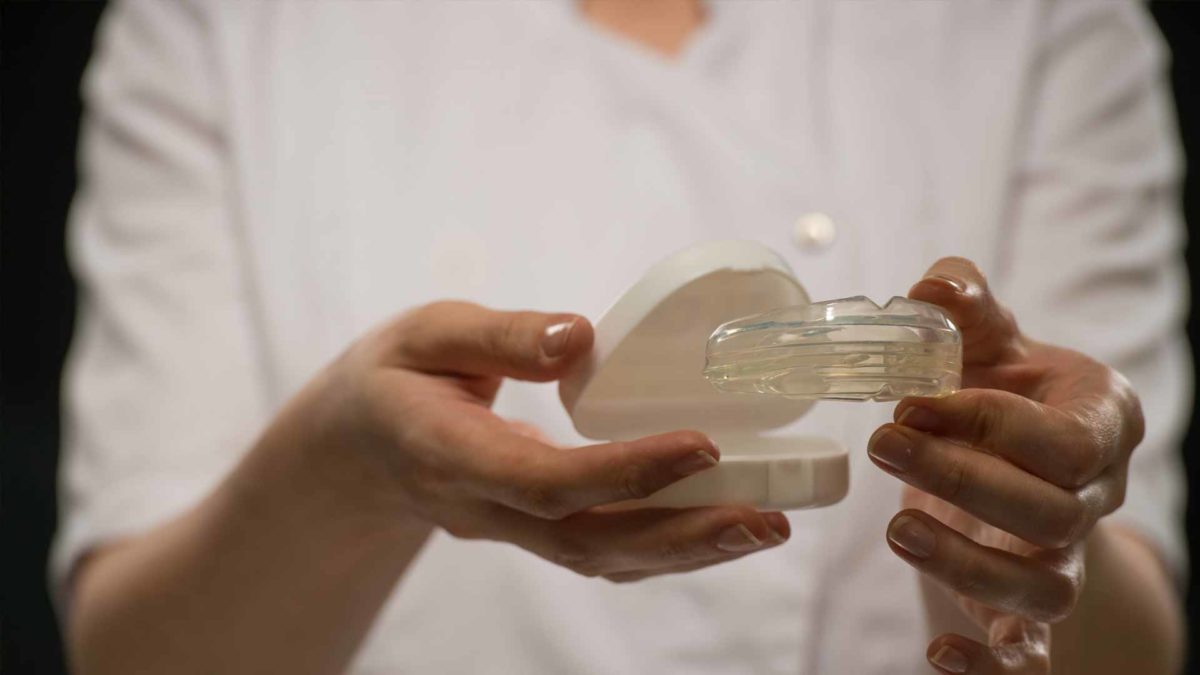 Clear custom mouth guard being held