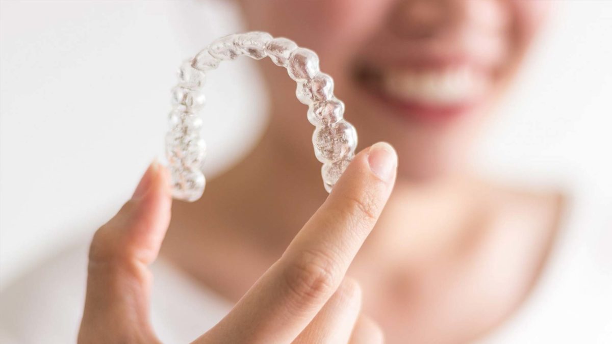 Clear custom mouth guard being held