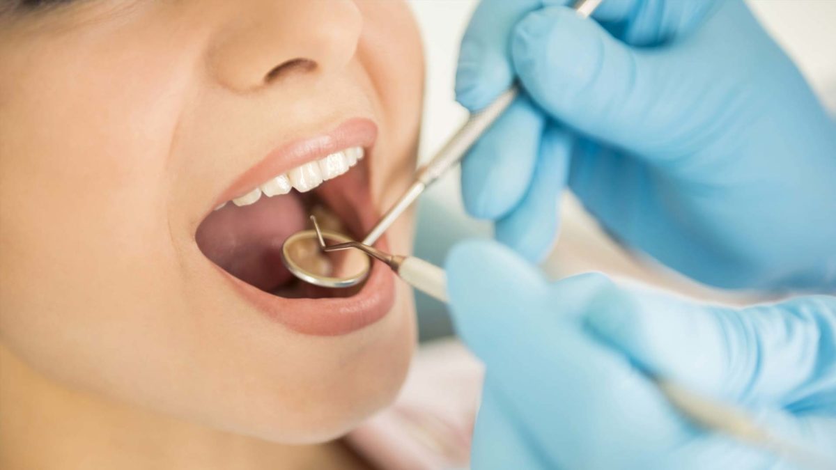 A lady getting dental check up
