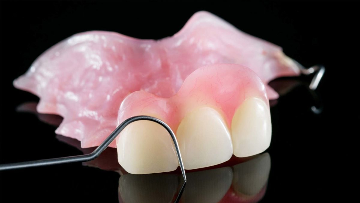 Denture in black background