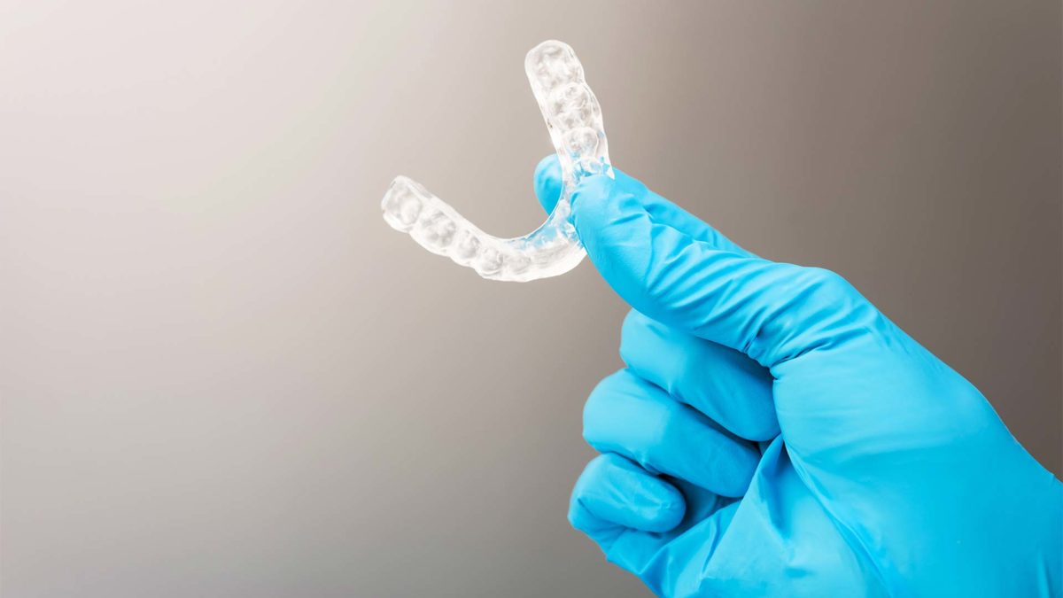 Clear custom mouth guard being held