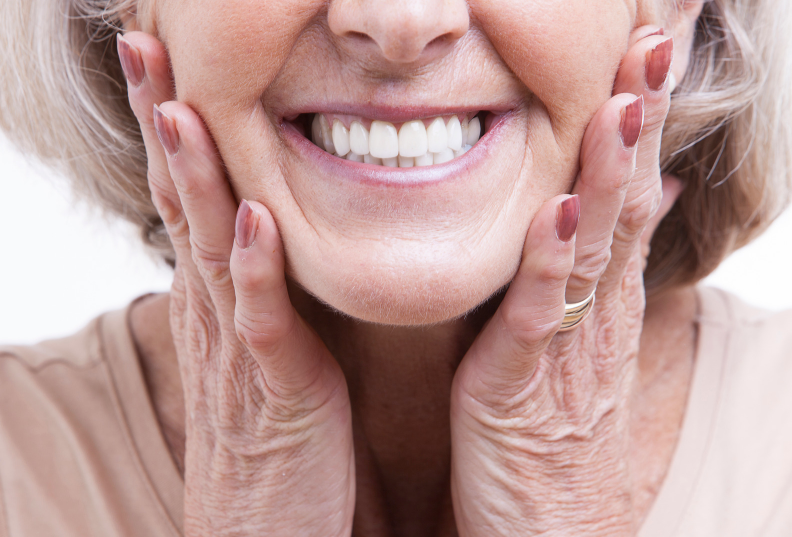 A old lady showing her teeth dentures