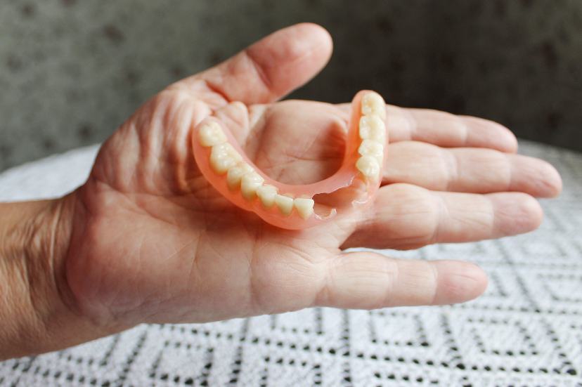 a person holding flexible partial dentures