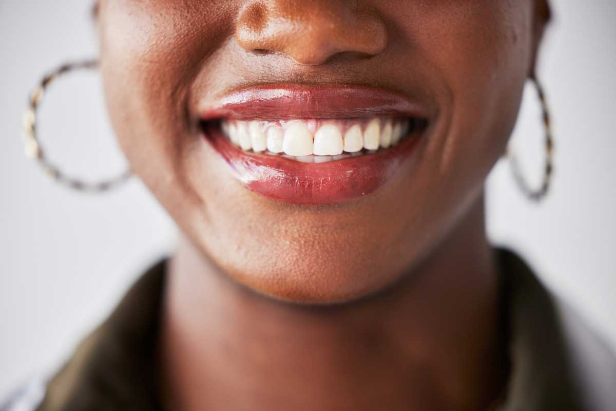 a close-up of a woman with a bright white smile