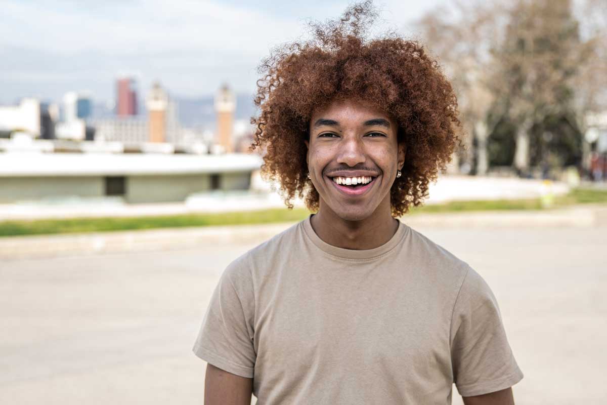 a young man smiling at the camera