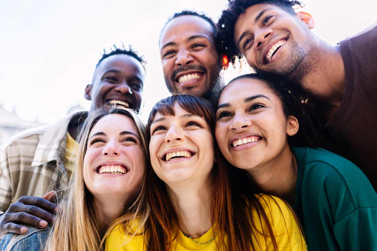 a group of young people smiling at the camera