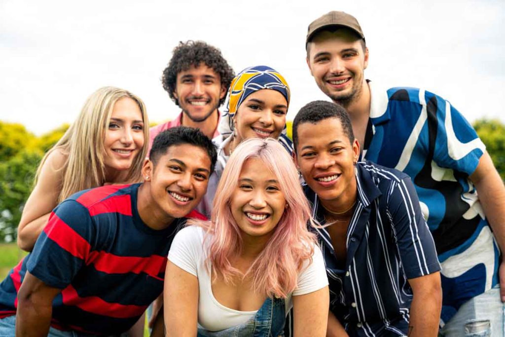 a group of young people smiling at the camera