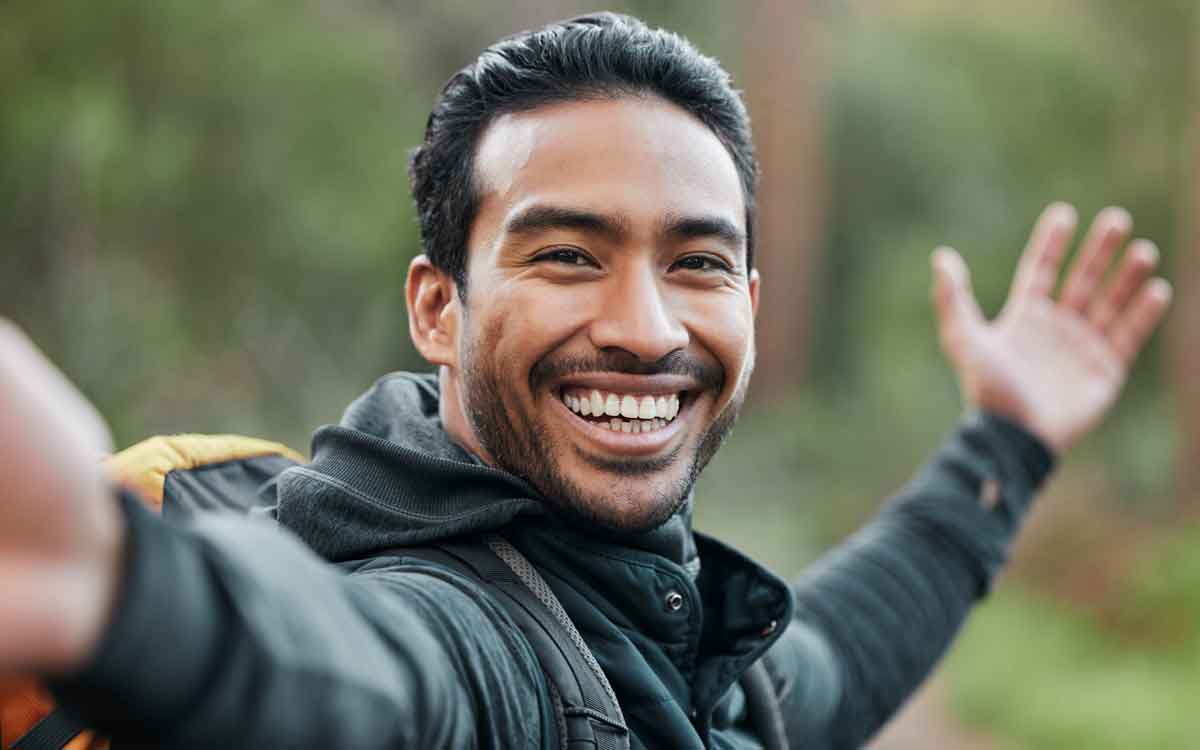 a young man smiling at the camera