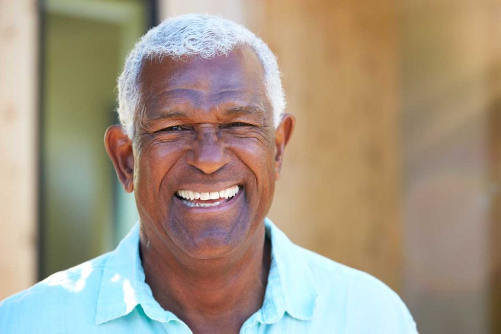 an older african american man smiling at the camera