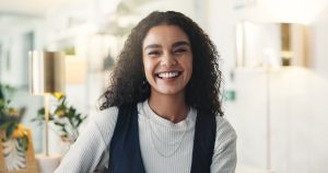 Confident young professional smiling in a modern, well-lit office setting