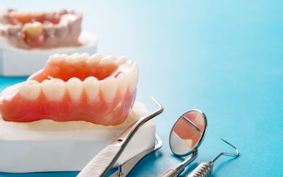 Close up , Complete denture or full denture on blue background.